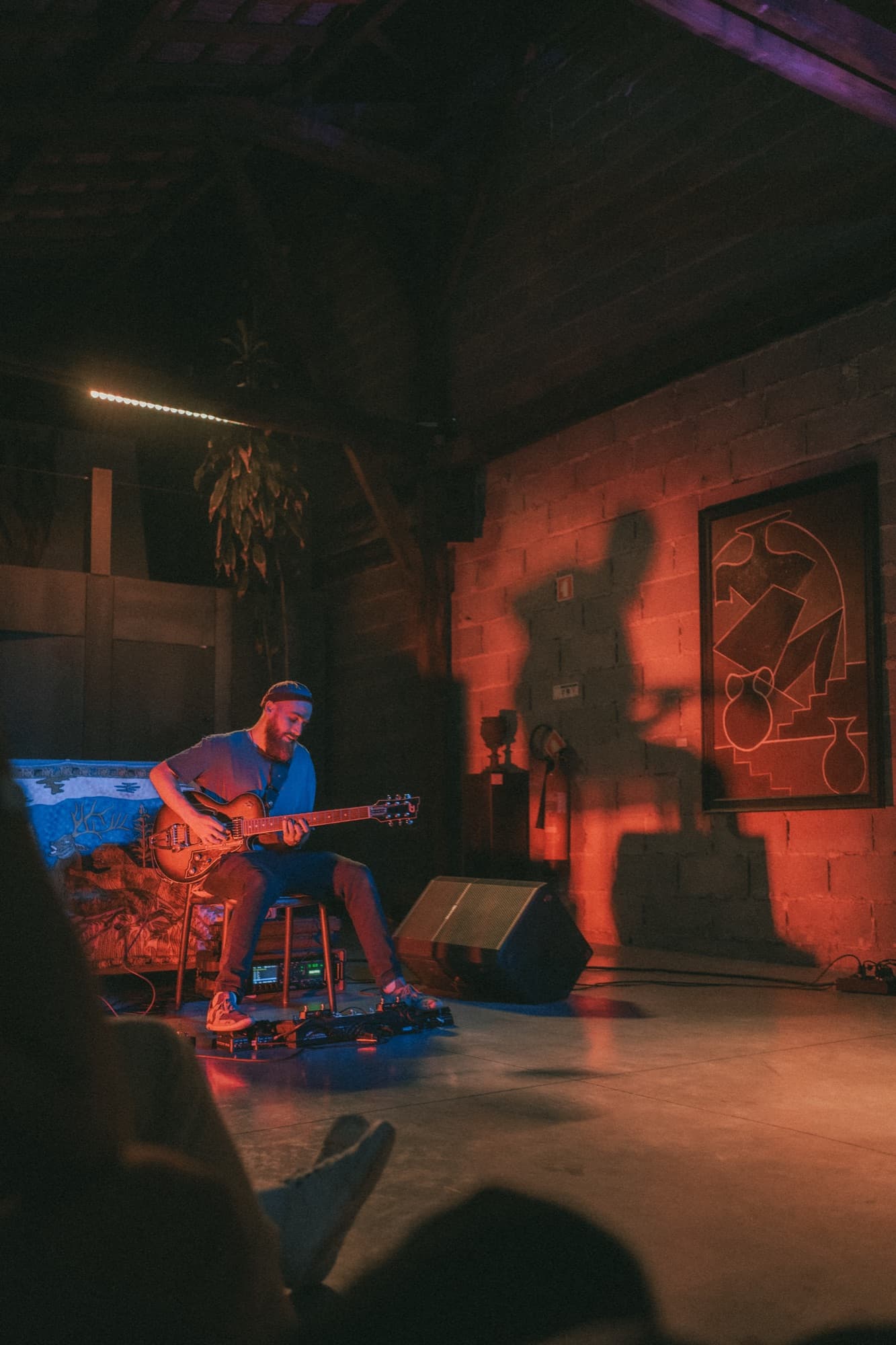 A musician playing under red light.