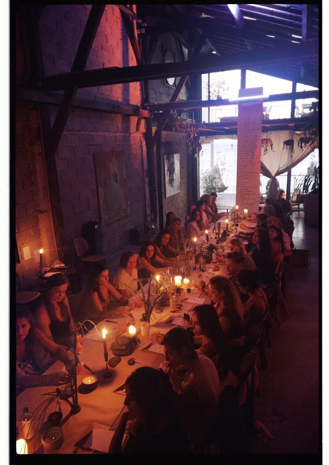 A long table lit with candles.