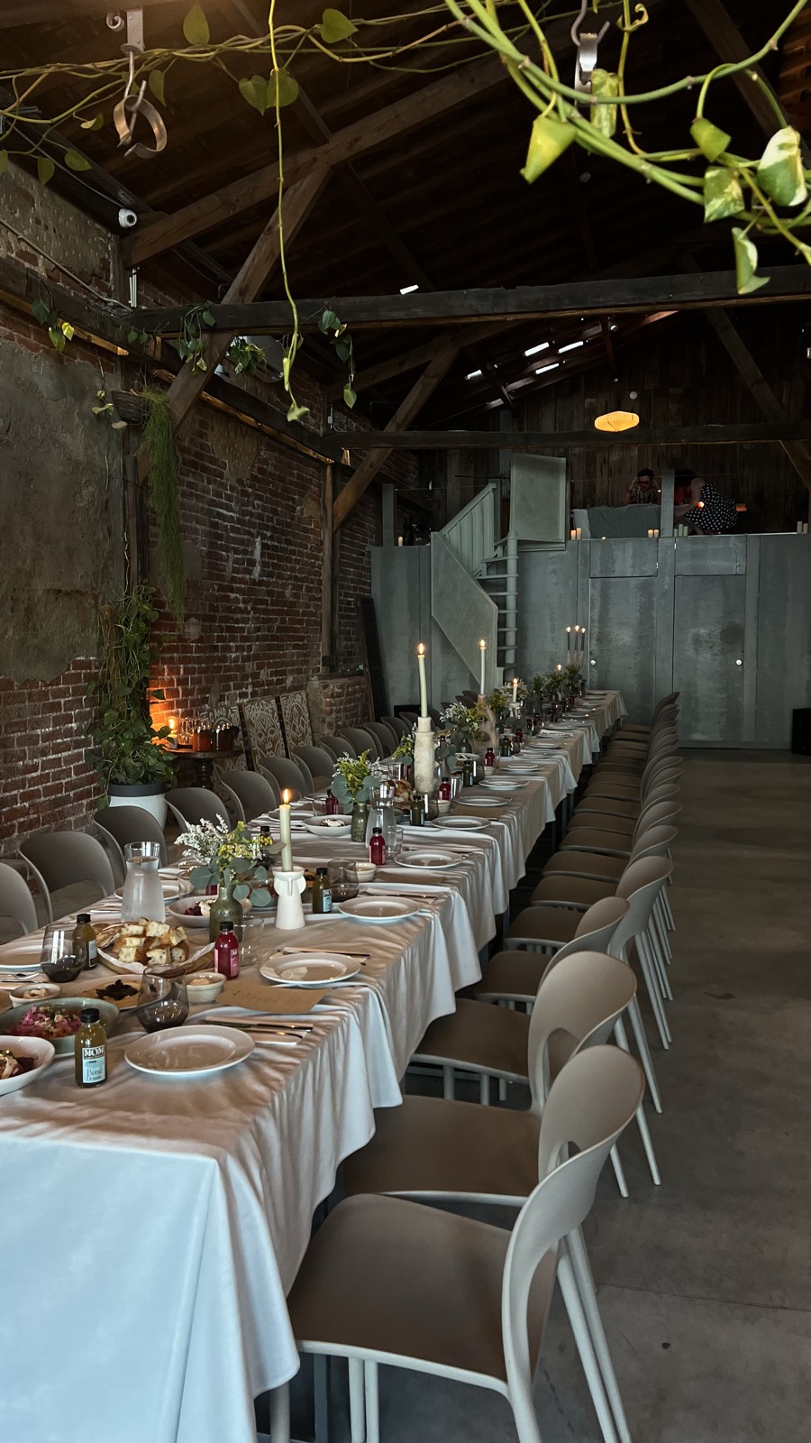 the main hall at teja set as one long table under the brick wall, candles down the middle